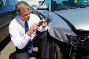 Insurance Adjuster Inspecting a Damaged Car